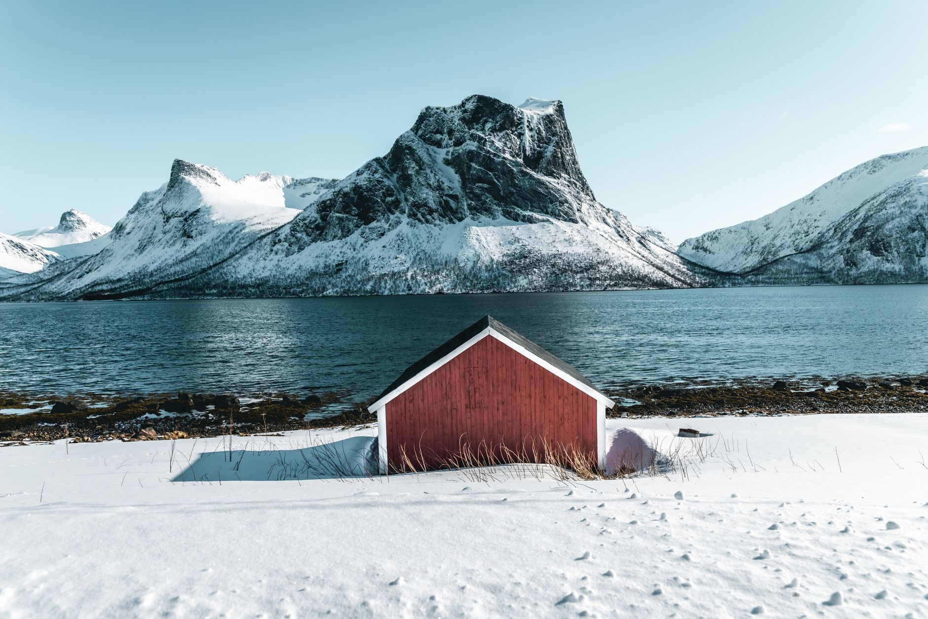 Snowcapped mountain fjord and serene Scandinavian waters