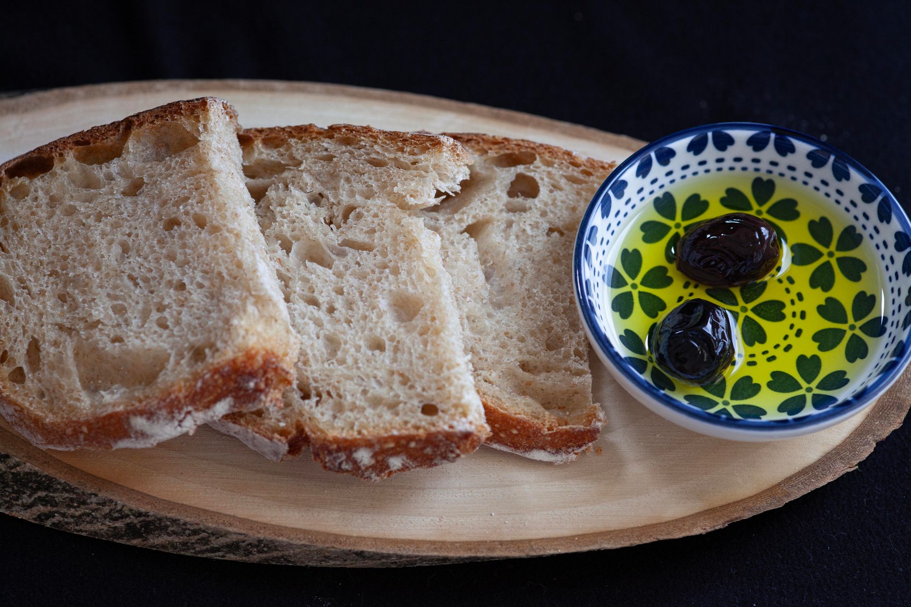 Rustic table setting with organic olive oil and bread in Italian countryside